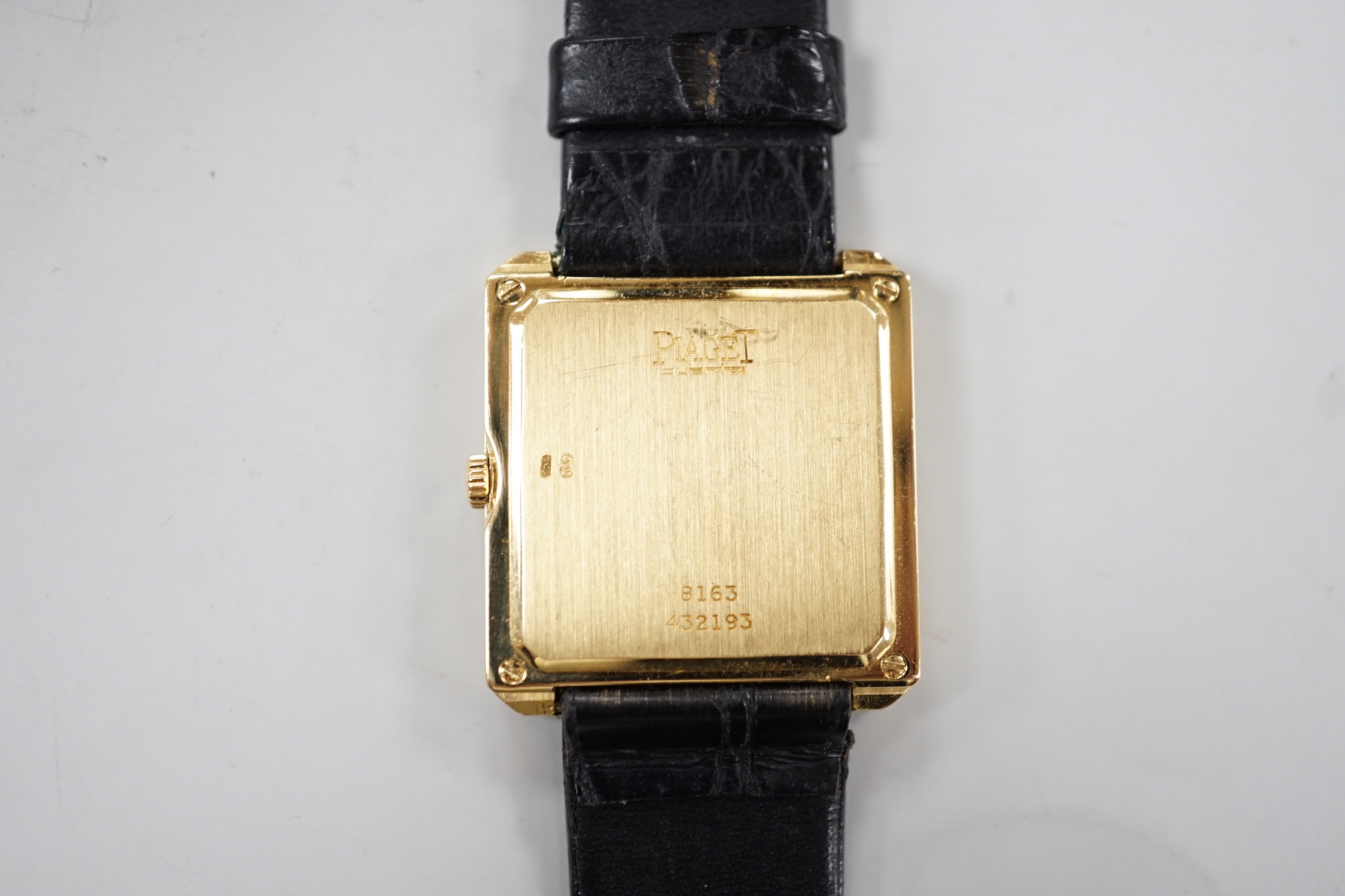 A gentleman's modern 18ct gold Piaget quartz dress wrist watch, with 'blind' rectangular dial, on associated leather strap, case diameter 26mm, no box or papers.